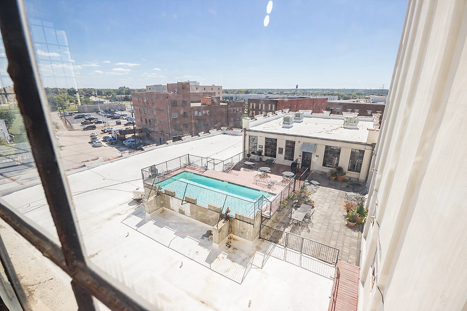 Window View Showing Sparkling Rooftop Pool at American Beauty Mill Apartments in Dallas, Texas