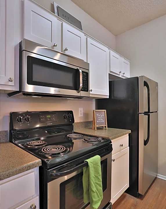 Fully Equipped Kitchen with Black Appliances at Ashton Oaks Apartments