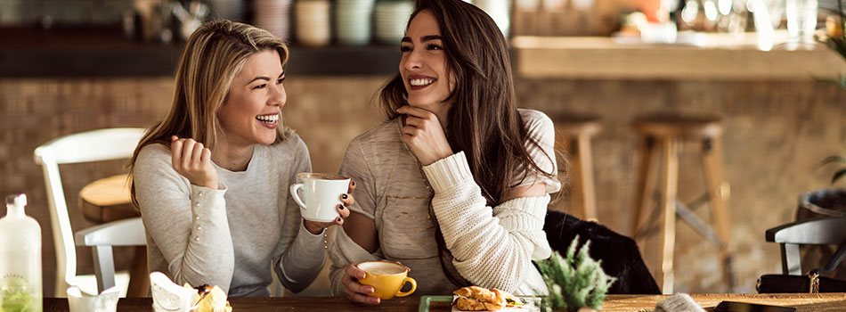 Two Ladies Hanging Out Over a Cup of Coffee 