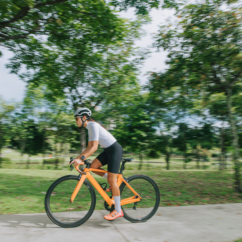 Man biking in the morning in full gear at the park