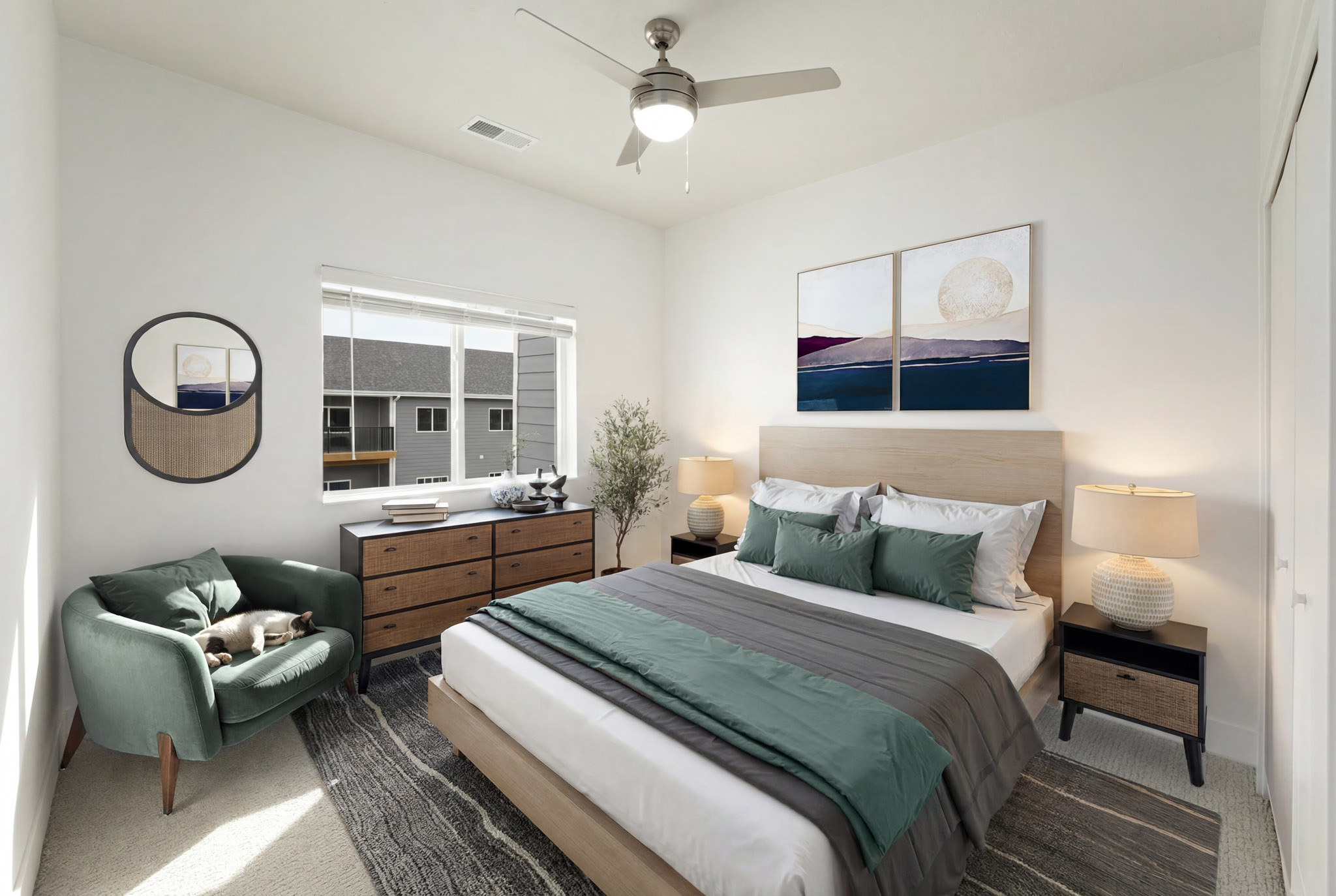 Staged bedroom with large window, ceiling fan, and spacious layout.