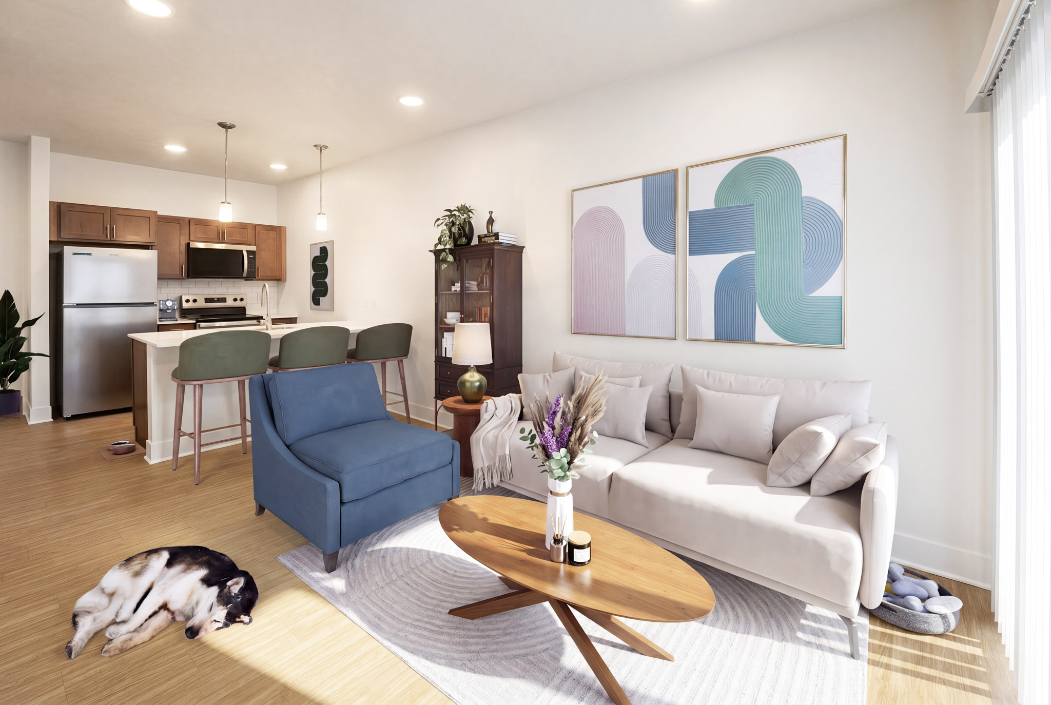 Staged living room with breakfast bar, pendant lighting, stainless steel appliances, and wood-style flooring.