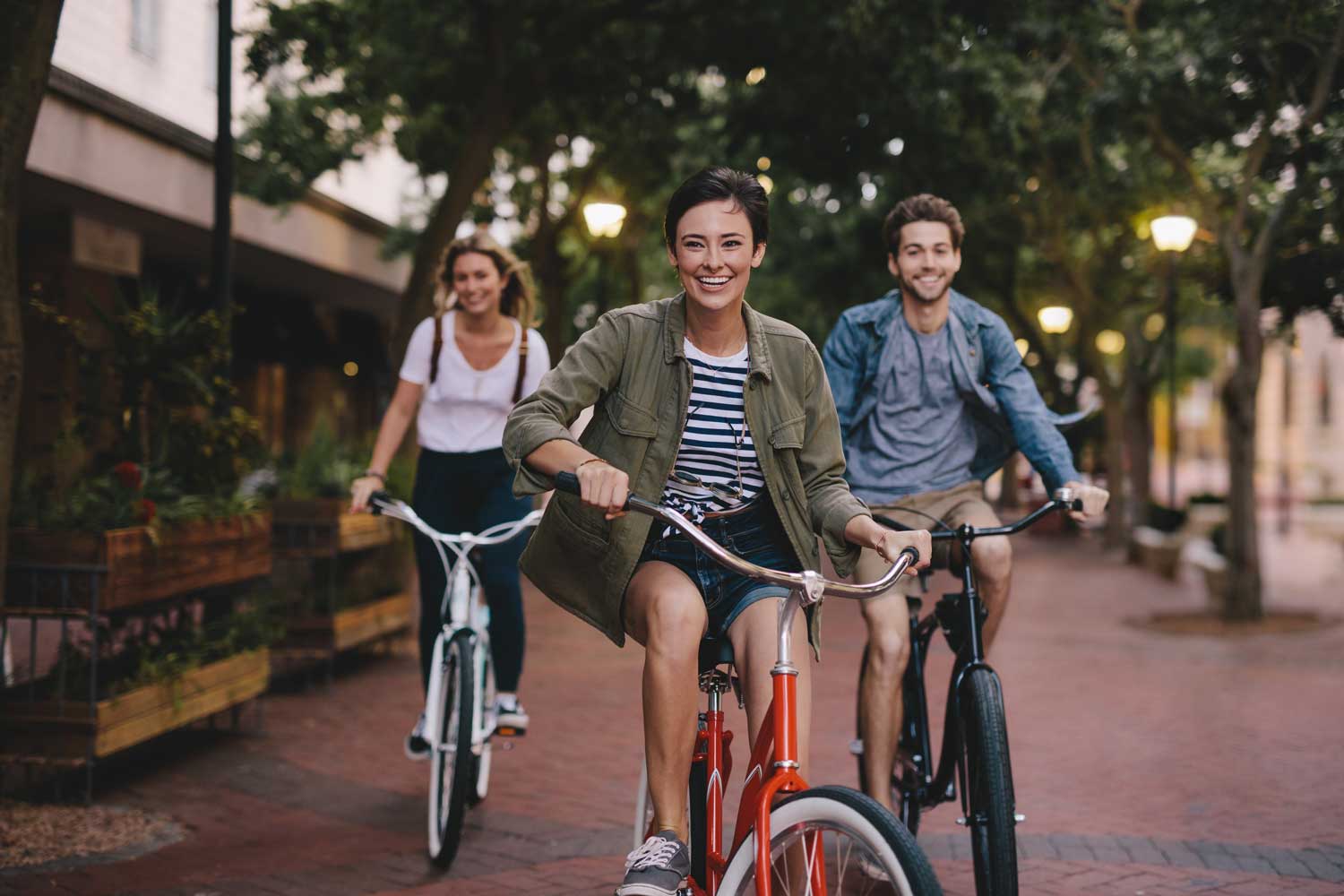 Three Friends Happily Riding on their Bicycle
