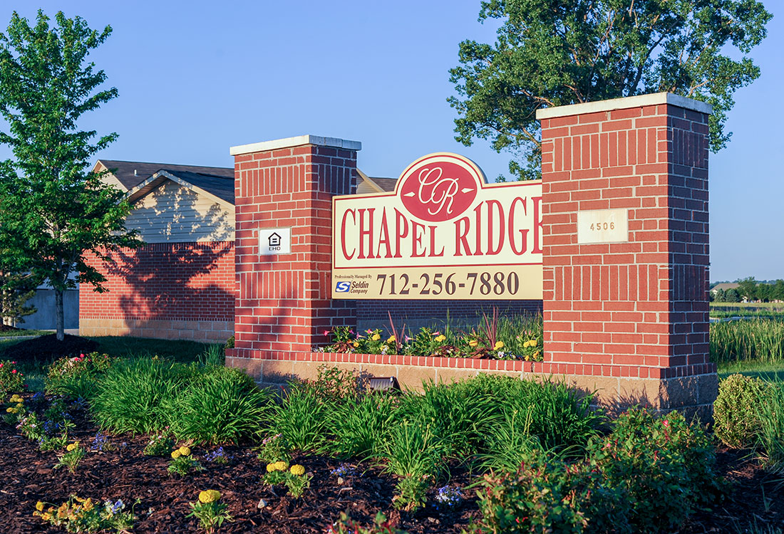 Property Sign at Chapel Ridge of Council Bluffs Apartments in Council Bluffs, IA