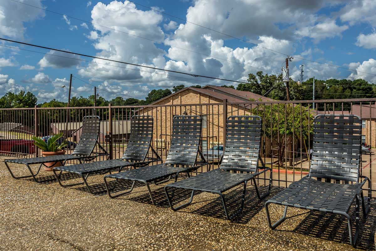 Poolside Chaise Lounge Chairs at Chevy Chase Apartments in Nacogdoches, Texas