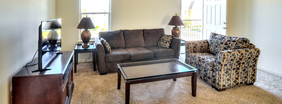 Carpeted Living Area. with TV at Cypress Bend Apartments