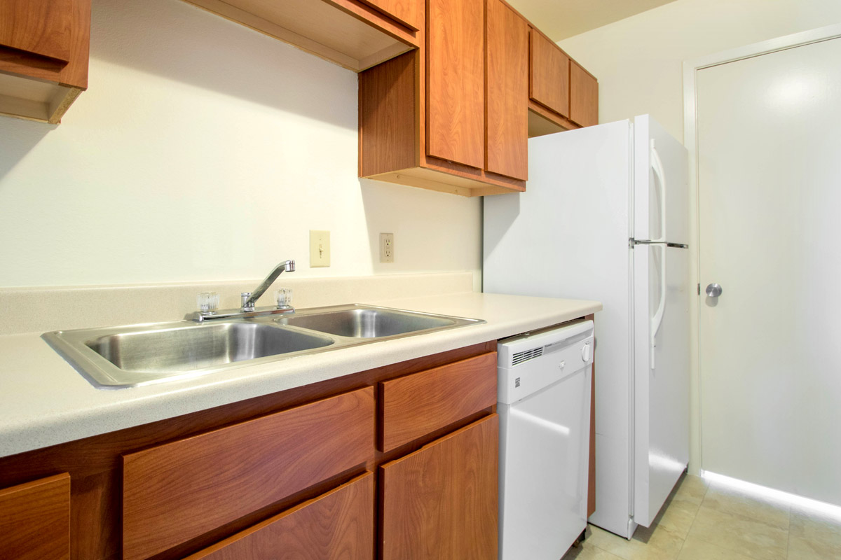 Spacious Kitchens with White Appliances at Cypress Bend Apartments