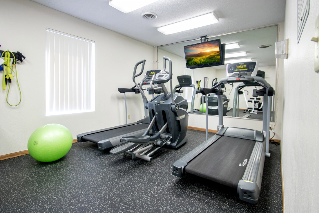 Modern Fitness Center with Widescreen TV Monitor