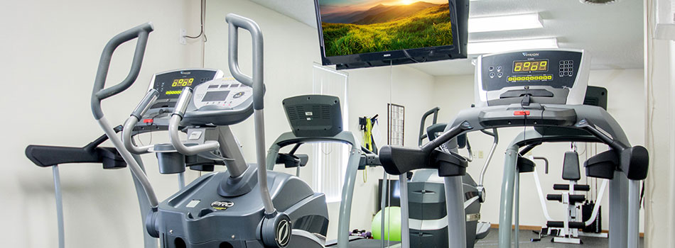 Modern Fitness Center with Widescreen TV Monitor