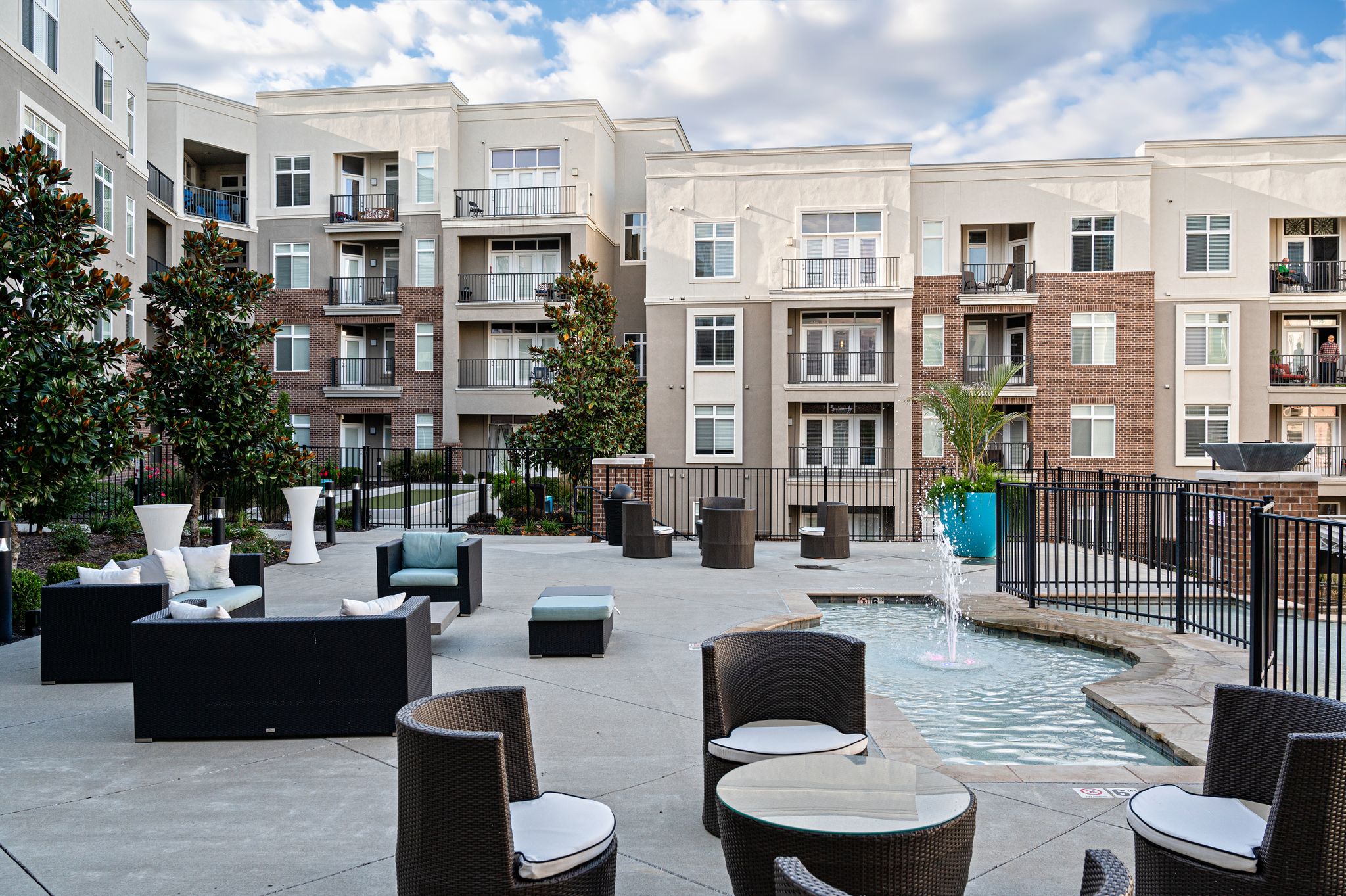 Outdoor Lounge by the Pool at Domain City Center Luxury Apartments
