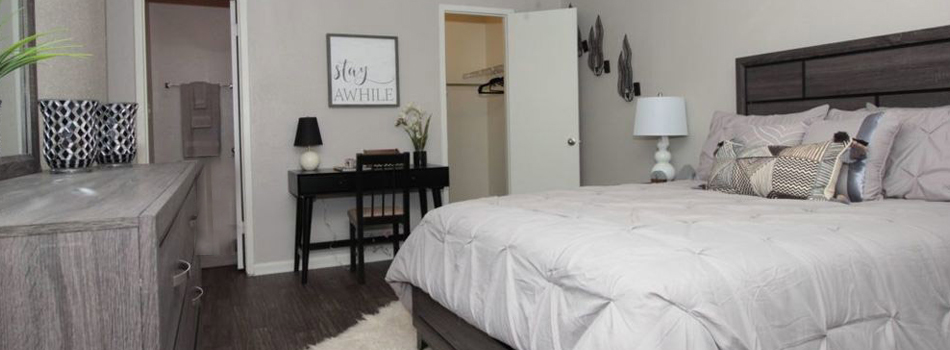 Bedroom with a view to the bathroom and closet space at O'Connor Oaks Apartment Homes