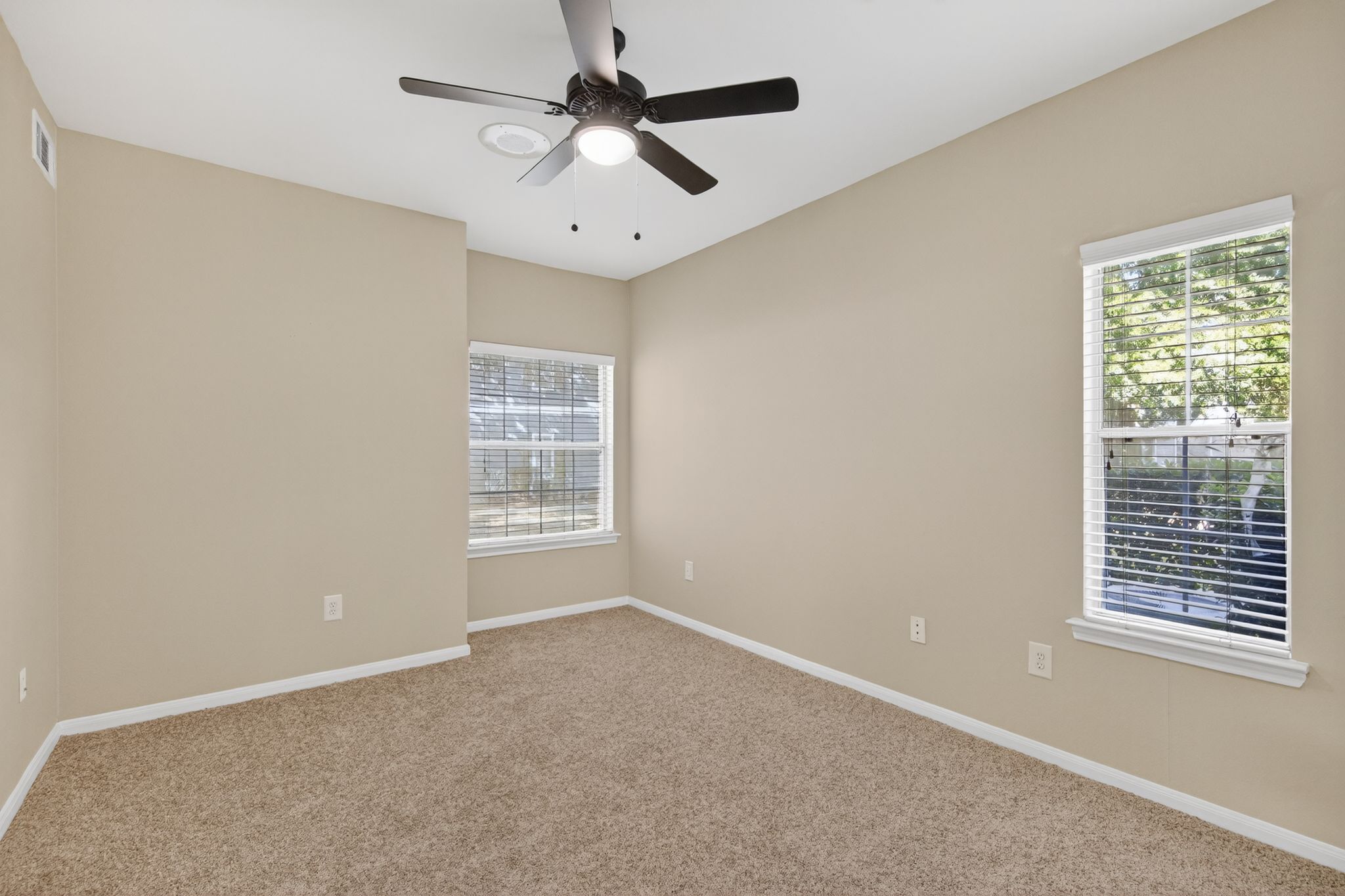 Entry area with wood flooring, built in shelves, white door, and a windowed door leading to the outdoor patio