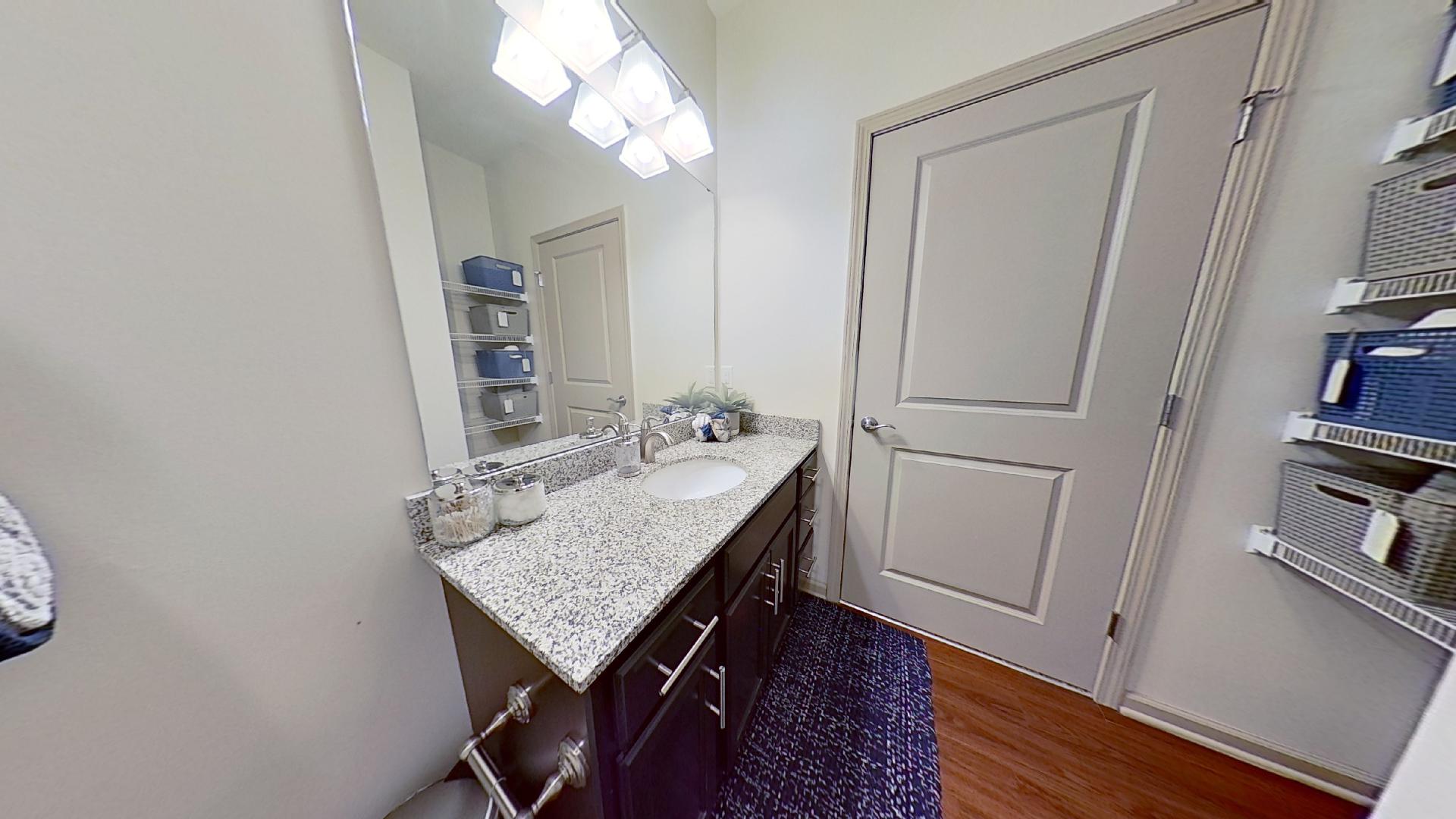 Bathroom With Ample Lighting at The Reserve at Fountainview Apartments