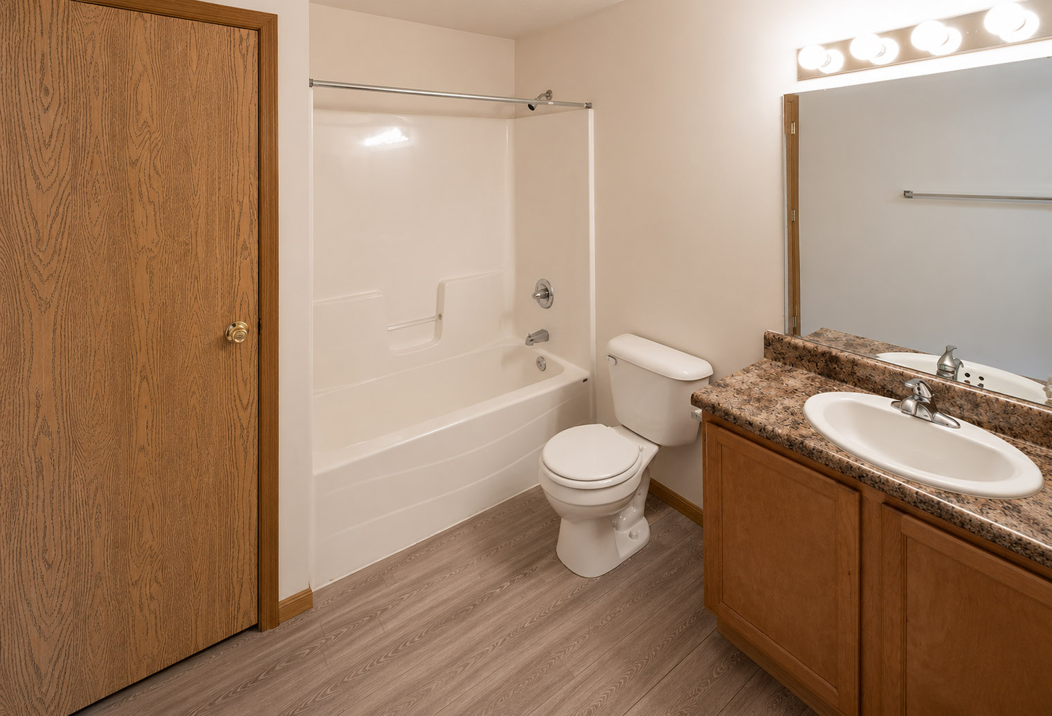 Highland Meadows Apartments in Bellevue, NE Built-in Shower and Tub Combination with Well-lit Vanity