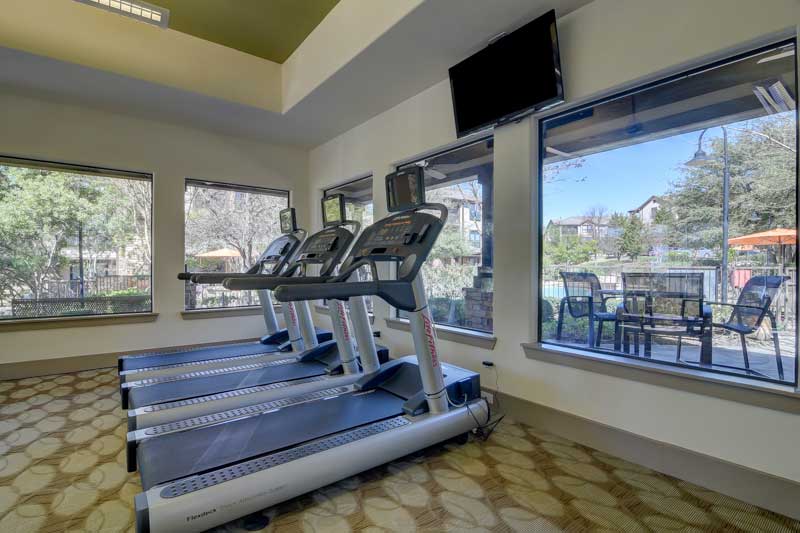 Gym Overlooking Pool Area at Hilltop at Shavano Apartments in San Antonio, TX