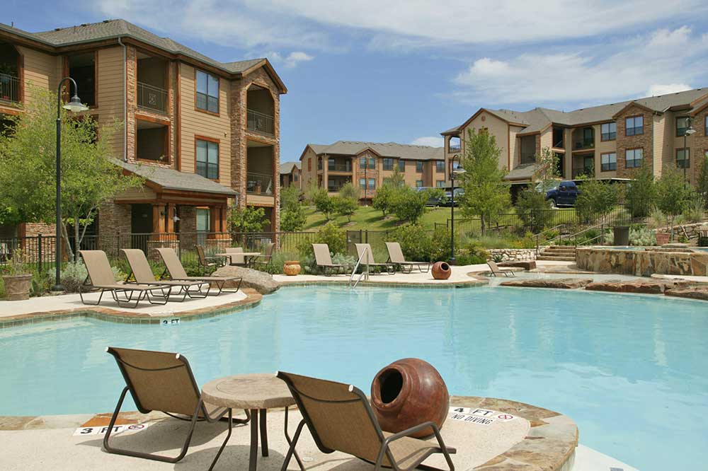 Lounge Chaises Surrounding Pool at Hilltop at Shavano Apartments in San Antonio, TX