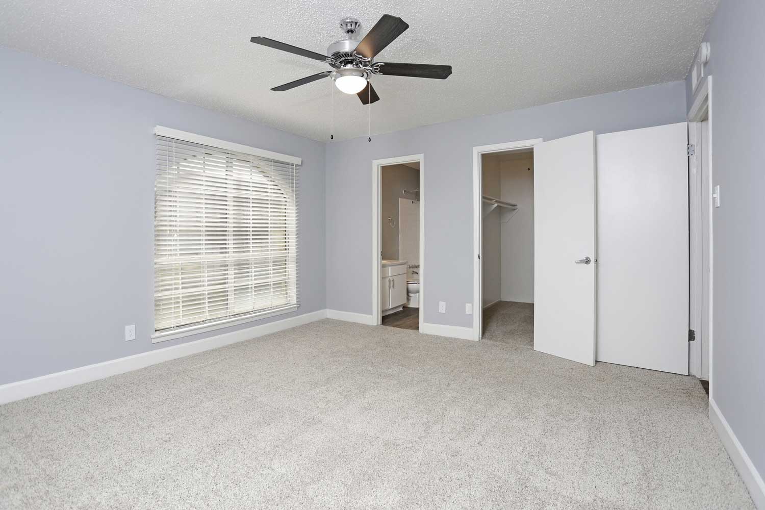 Spacious Bedroom with Ceiling Fans at The Junction Apartments in Arlington, TX