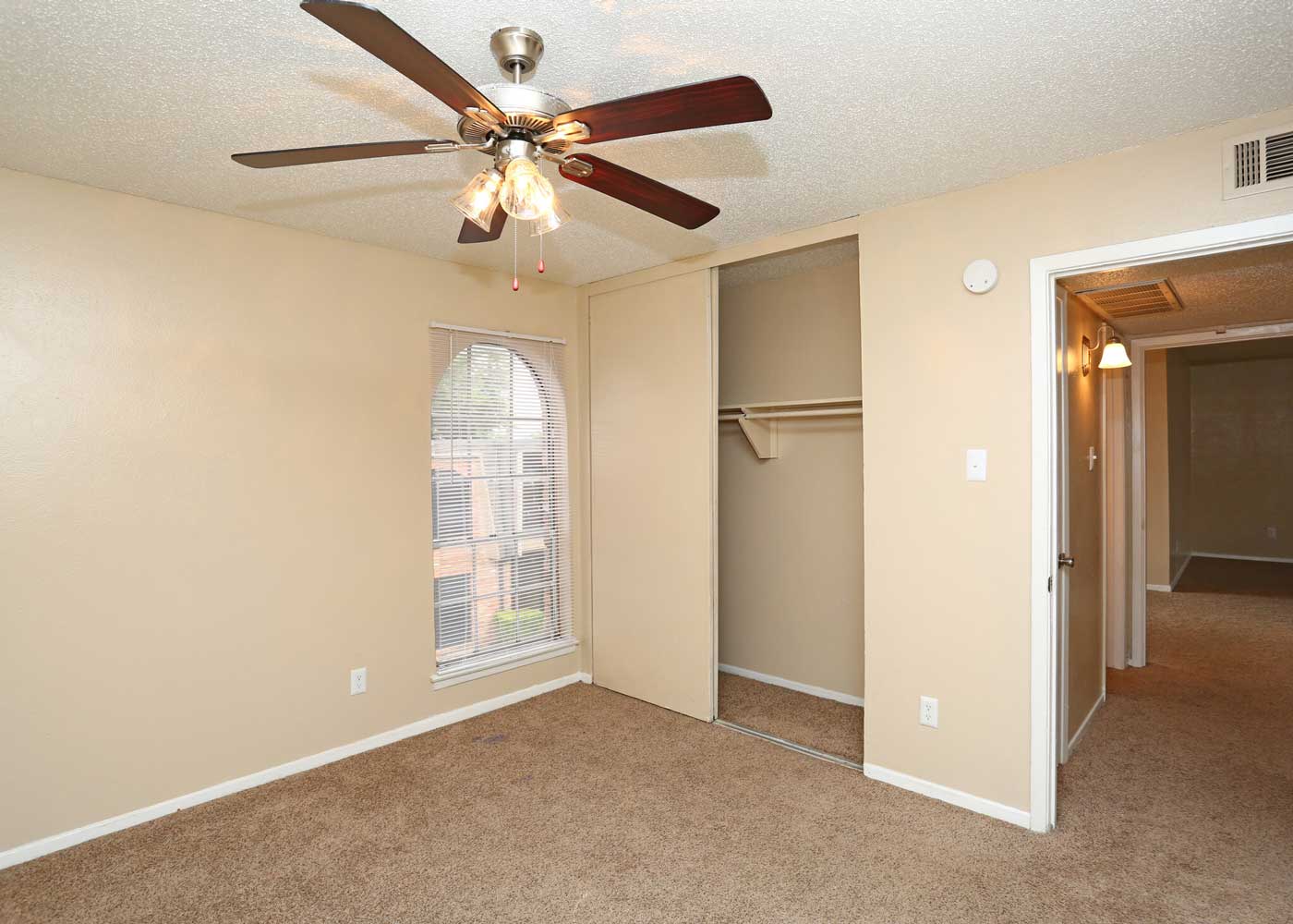 Bedroom with Closet and Ceiling Fans at The Junction Apartments