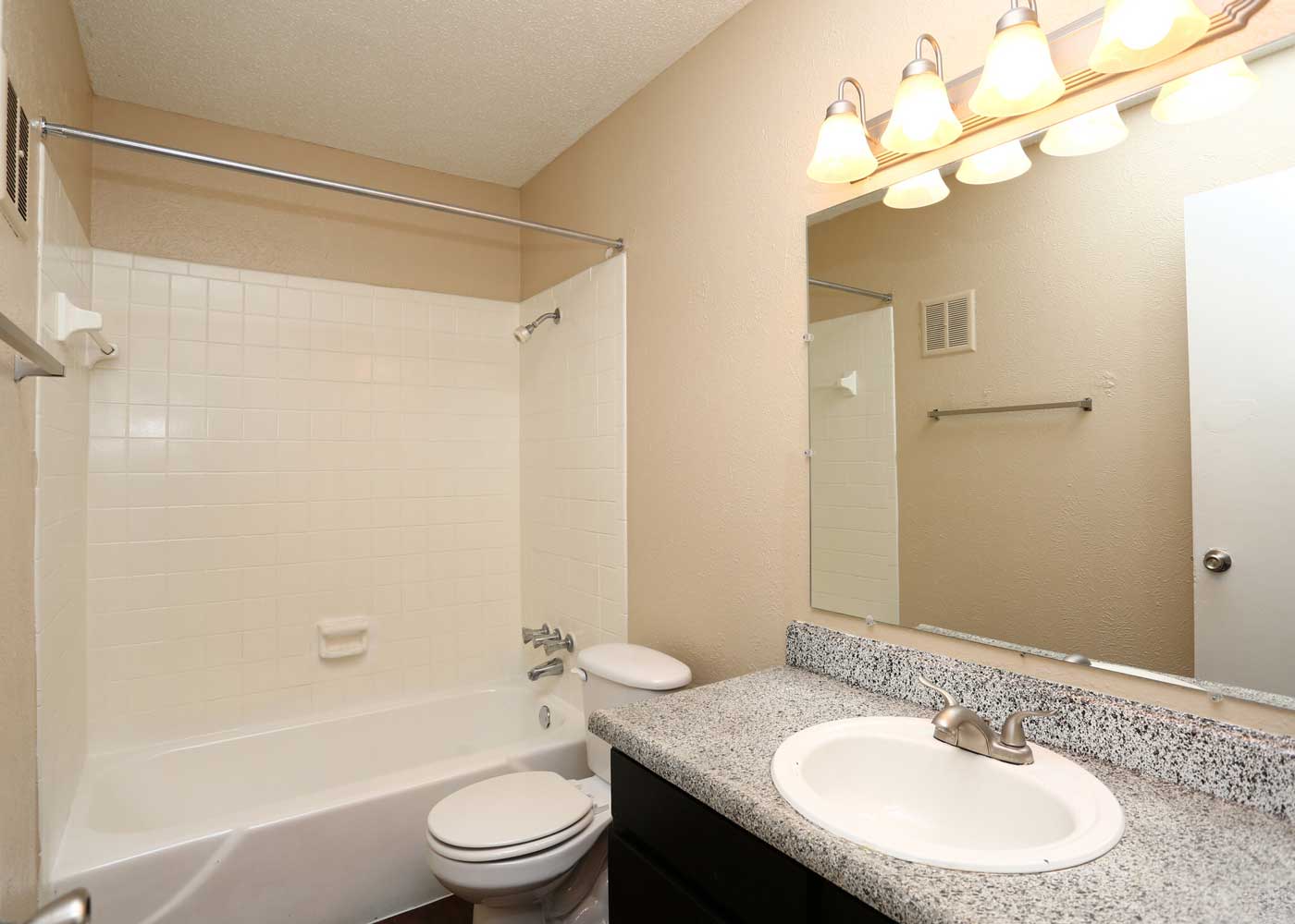 Bathroom with Shower and Tub Combination at The Junction Apartments in Arlington, TX