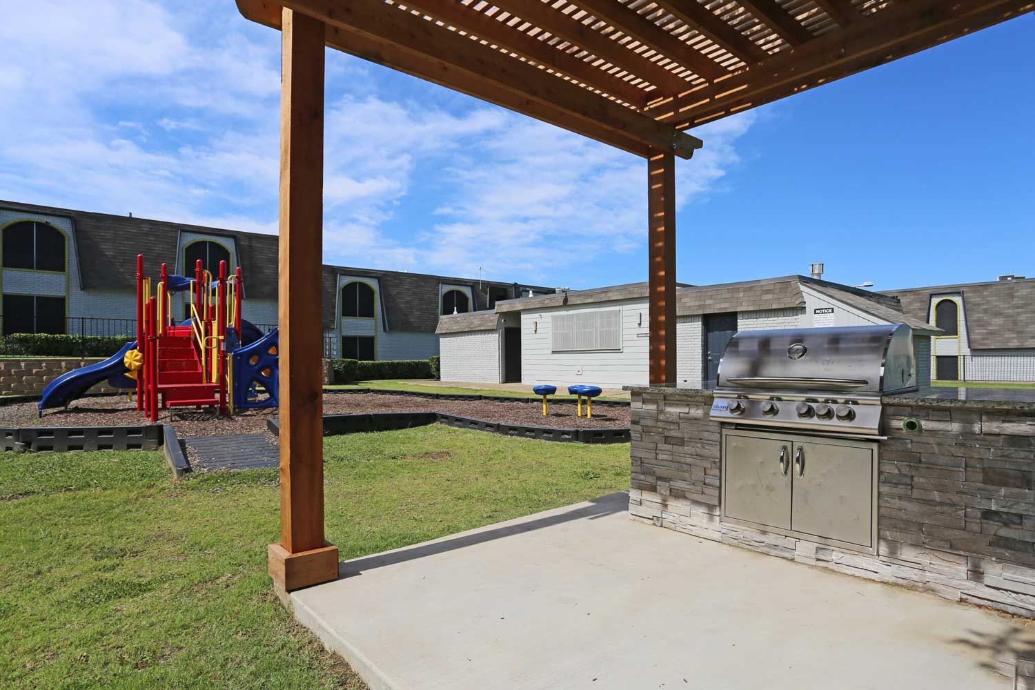 Outdoor Grill and Playground Area at The Junction Apartments in Arlington, TX