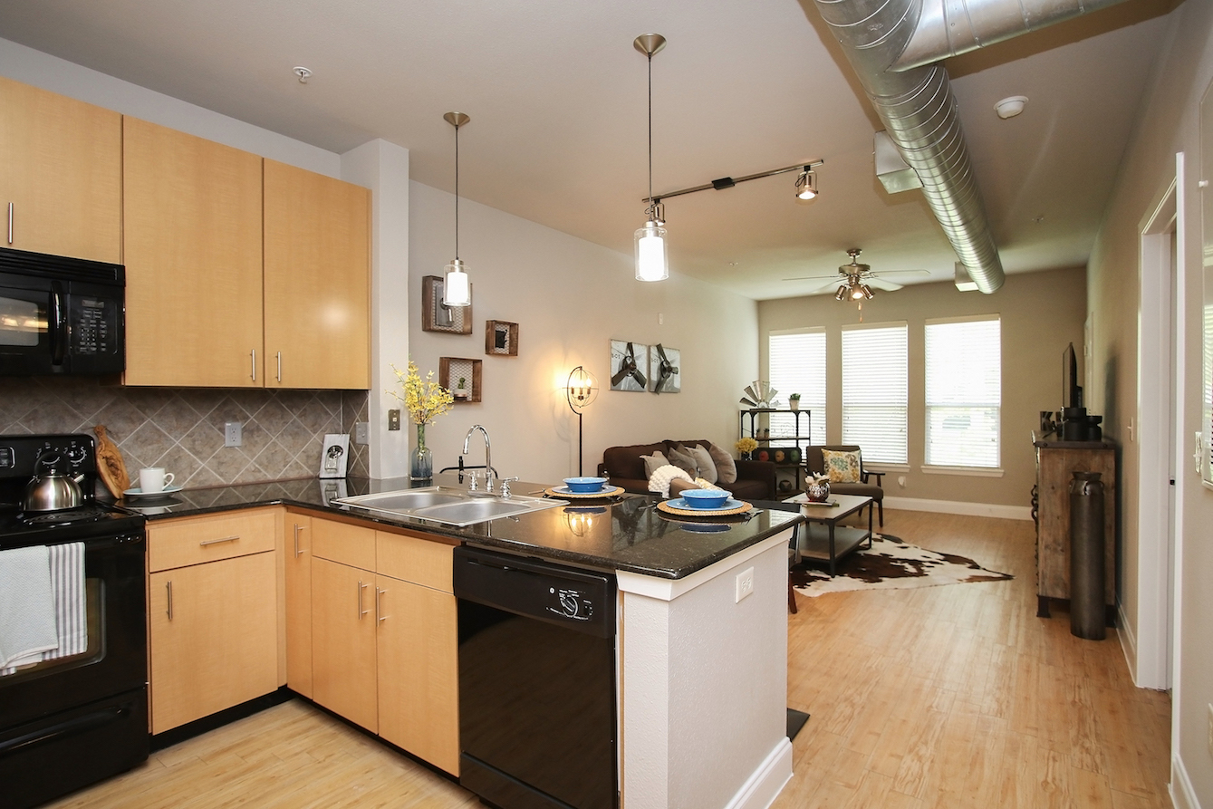 Kitchen with Pendant Lighting at King's Cove Apartments in Kingwood, Texas 