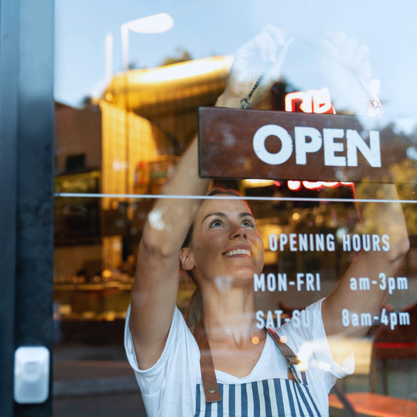 Waitress opening local shop in the morning