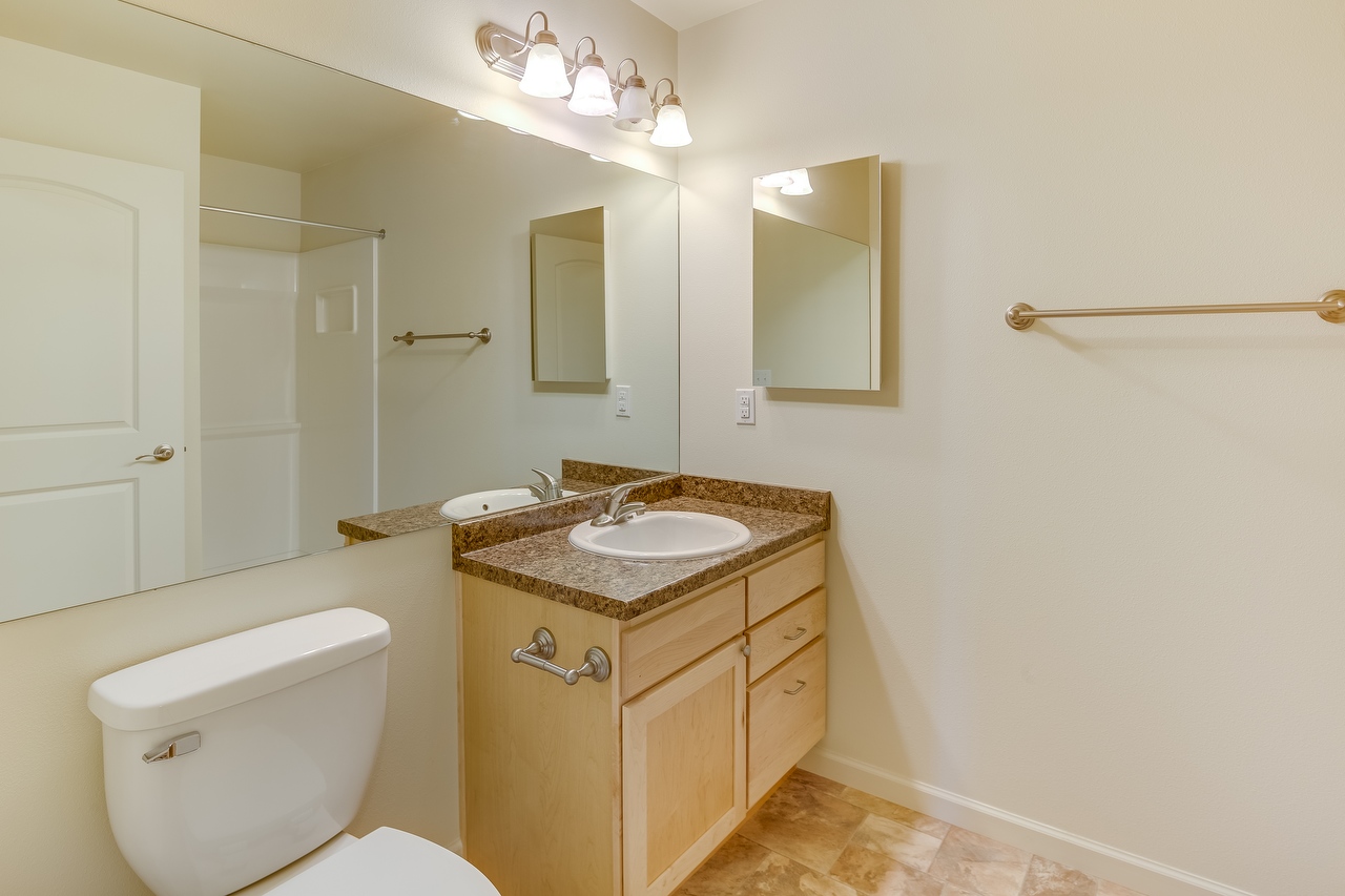 3Br Bathroom Interior with Wall Size Mirror and Single-Sink Vanity