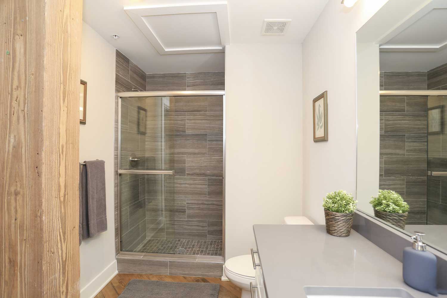 Bathroom with Vanity and Enclosed Shower in OGGI Lofts