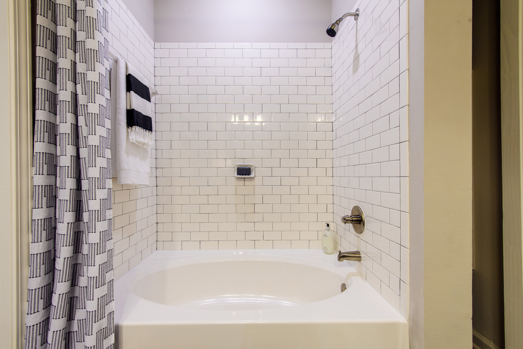 White subway tiled bathroom with oval soaking tub