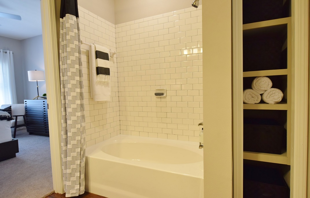 Park Rowe Village - Apartment 1115 - apartment bathroom with storage closet for towels