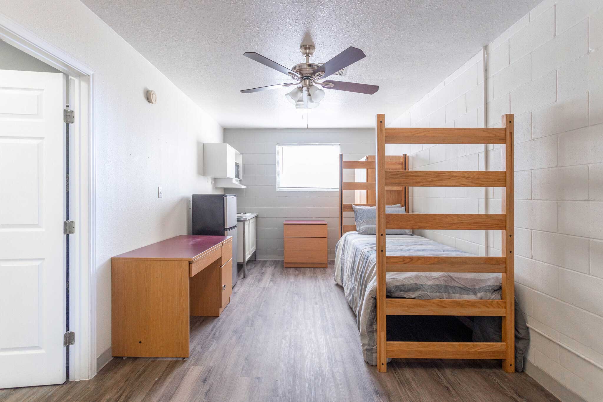 Bedroom With Ceiling Fan Available at Pelican Shores Apartments in Galveston, Texas