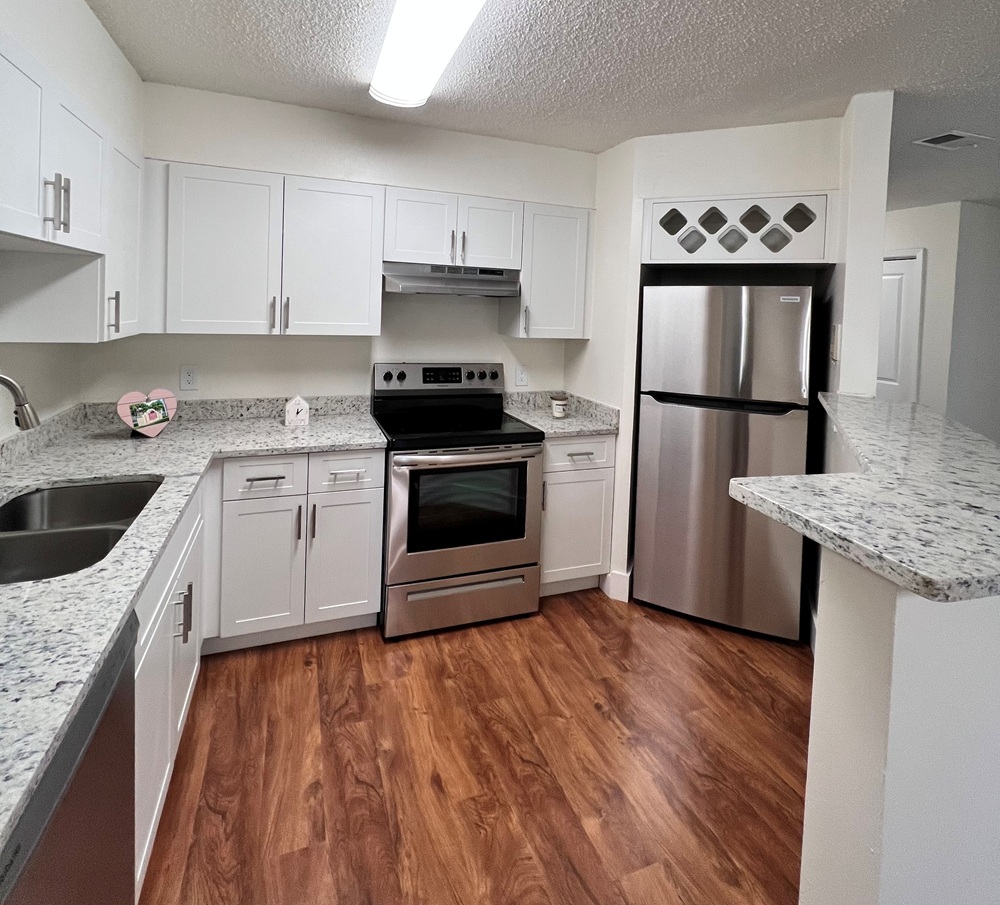 Modern kitchen with stainless steel appliances and granite countertops