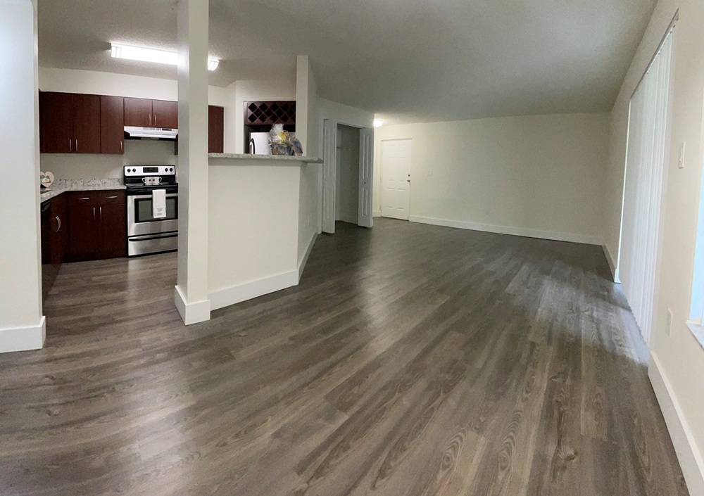 Spacious open-concept living area with modern kitchen.