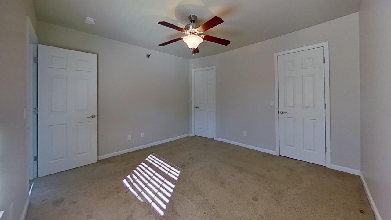 Bedroom With Ceiling Fan at Polo Downs Apartments in Fenton, MO