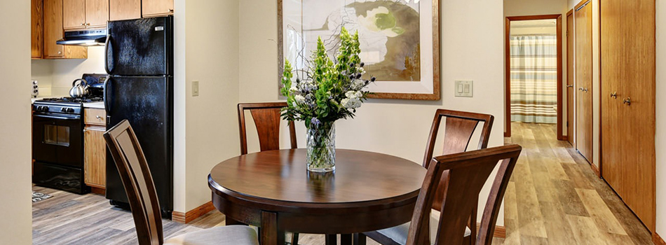 Dining table with a centerpiece at Portage Pointe Apartments