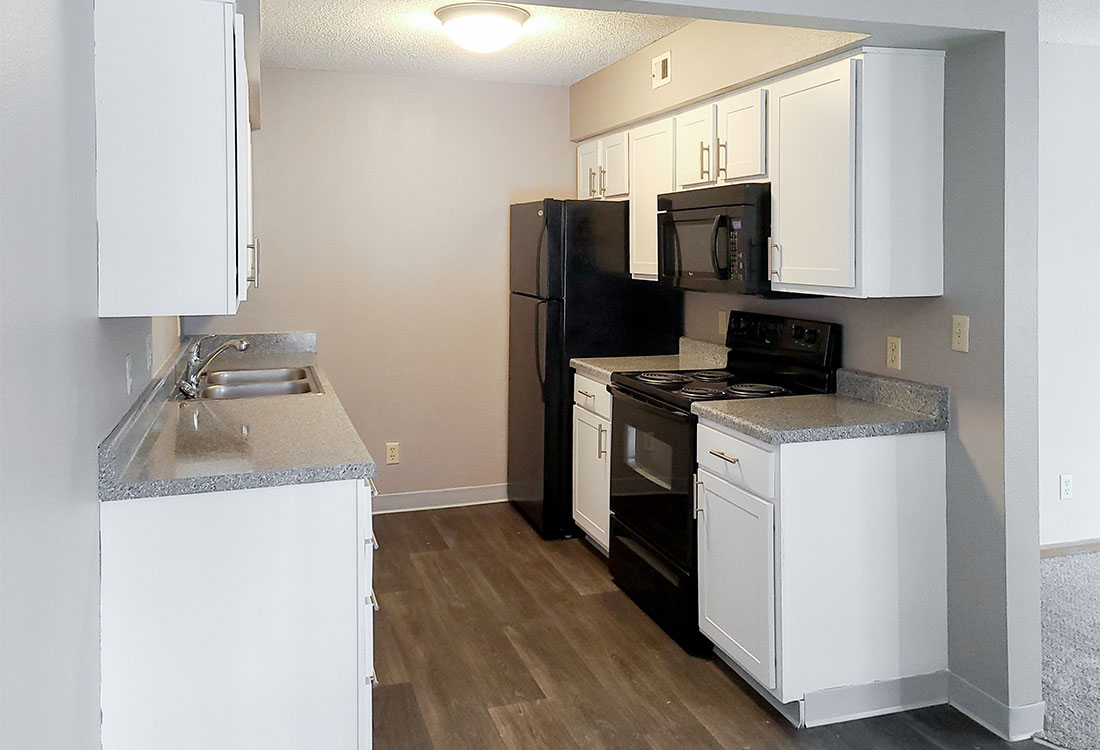 Upgraded White Kitchen with Black Appliances at Prairie West in North Ames, IA