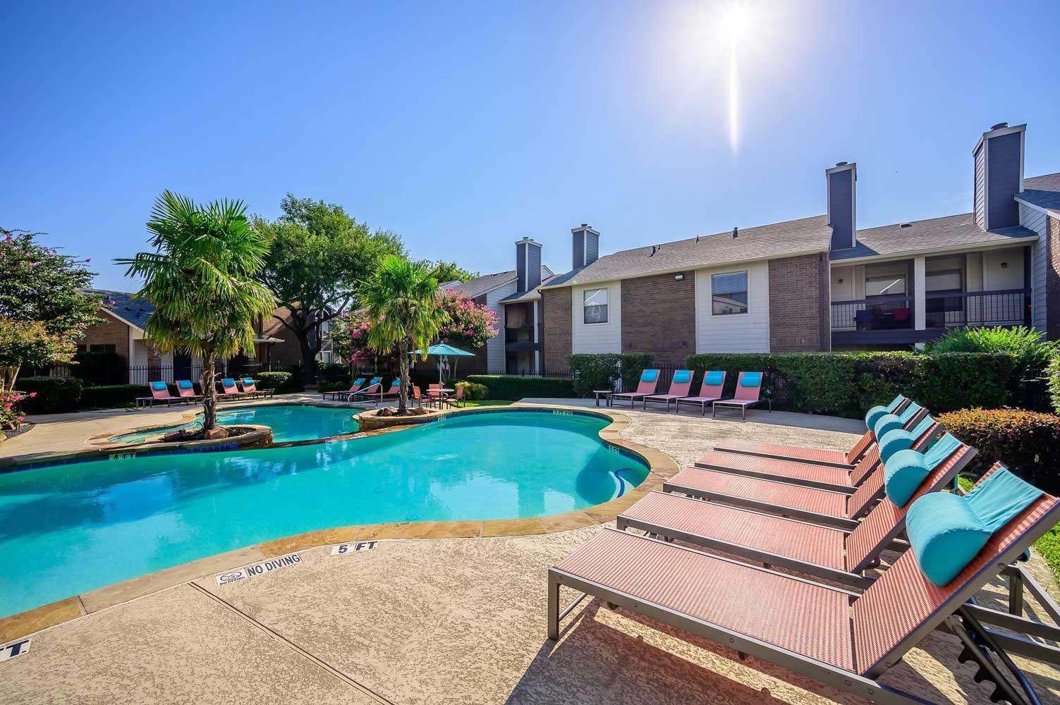 Pool with Designer Lounge Furniture at Ridgeview Place Apartments in Irving, TX