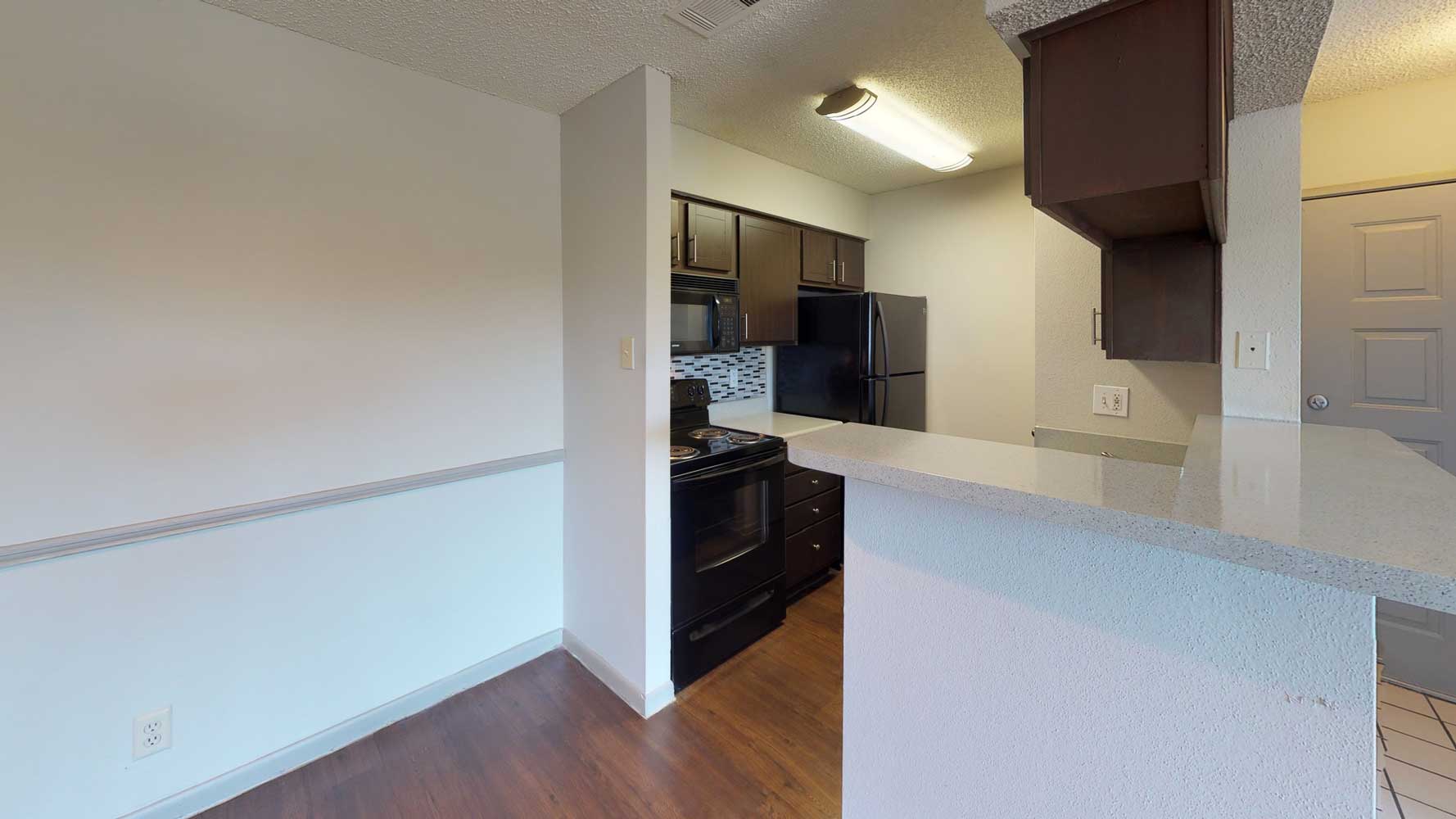 Kitchen with Bar at Ridgeview Place Apartments in Irving, TX