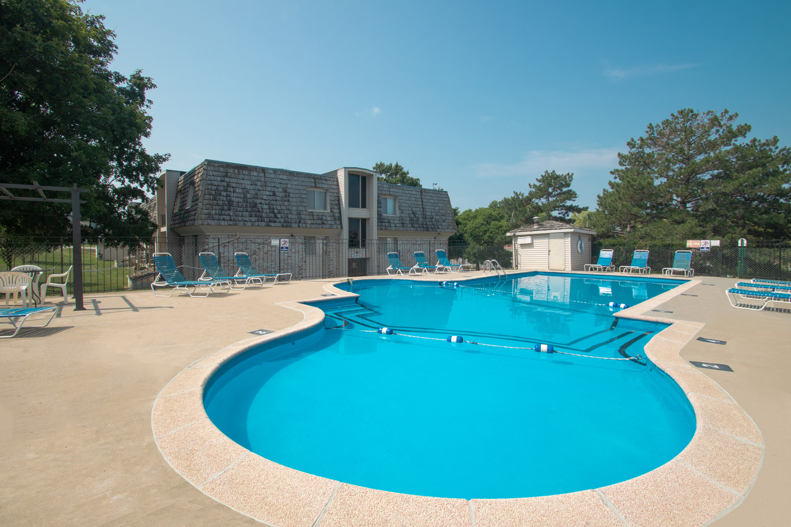 Swimming Pool with Sun Deck and Lounge Furniture at Pinehill Park Apartments in Bellevue, NE