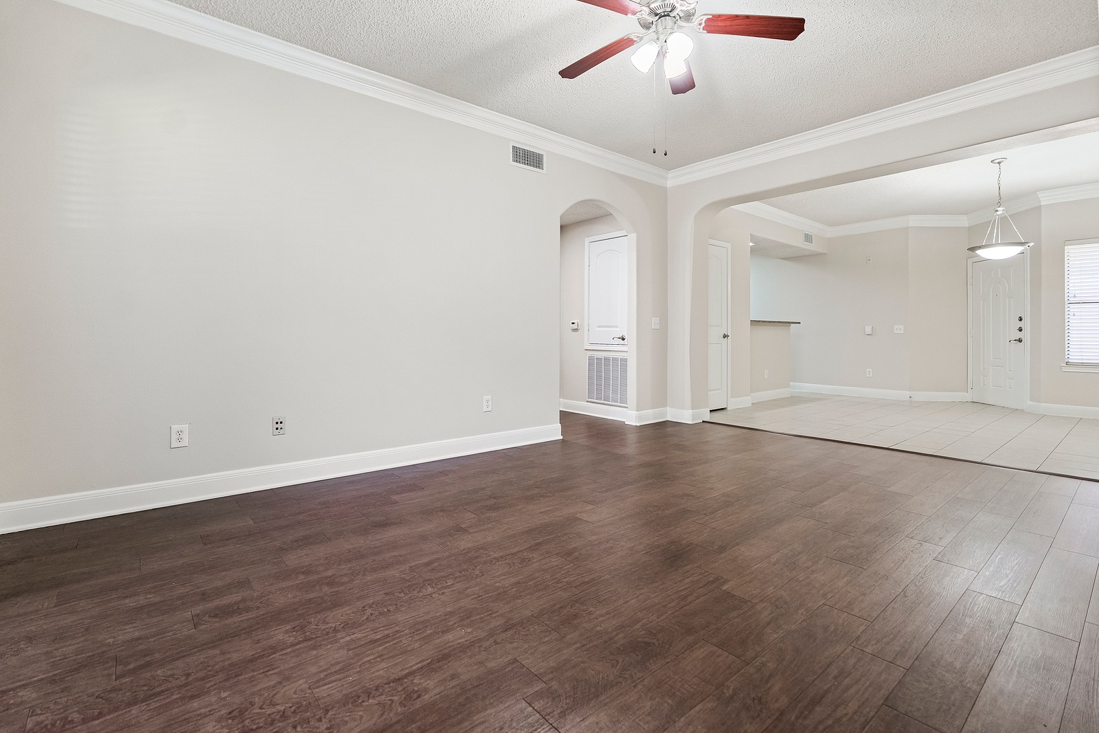 Open Living Room with Archways and Wood Flooring