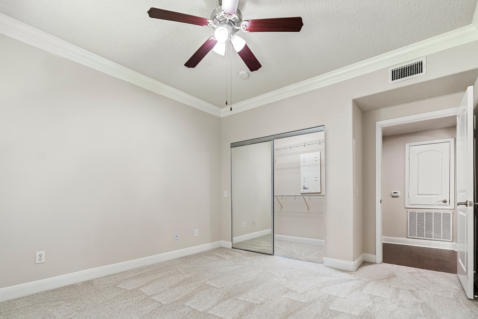 Spacious Bedroom with Mirrored Closet Doors