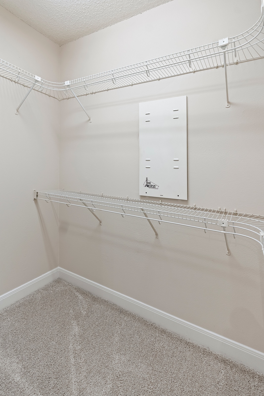 Spacious Closet with Wire Shelving and Carpet