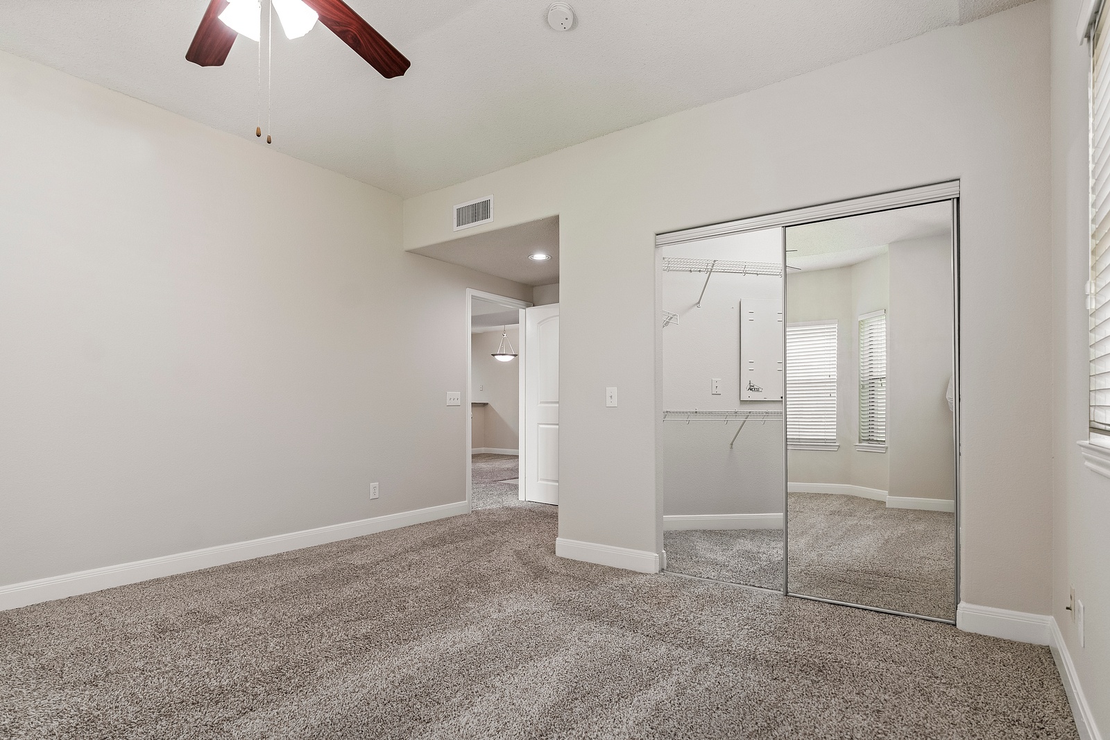 Spacious Bedroom with Mirrored Closet Doors