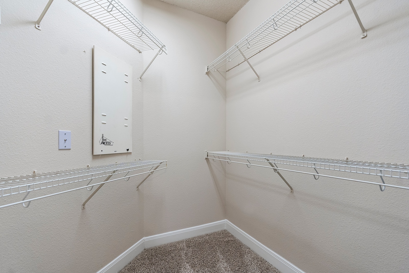 Spacious Closet with Wire Shelving and Carpet