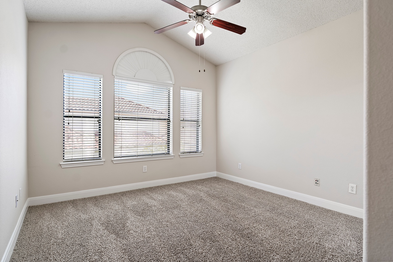 Spacious Bedroom with Arched Window Design