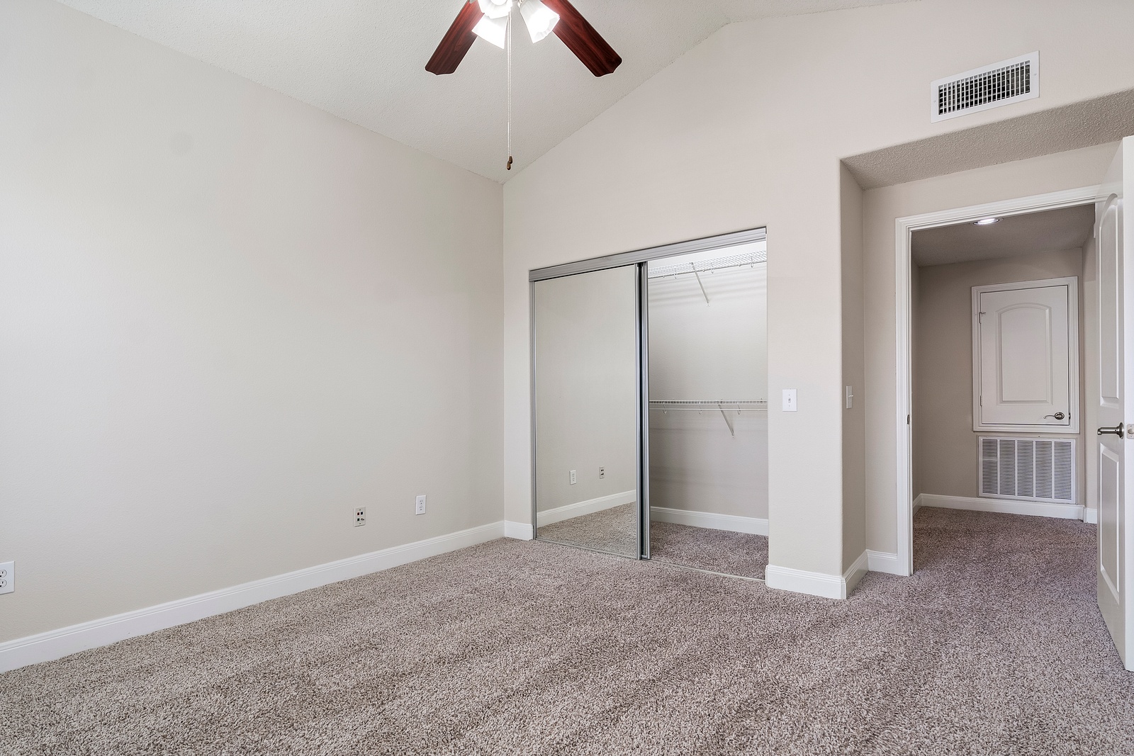 Spacious Bedroom with Mirrored Closet Doors