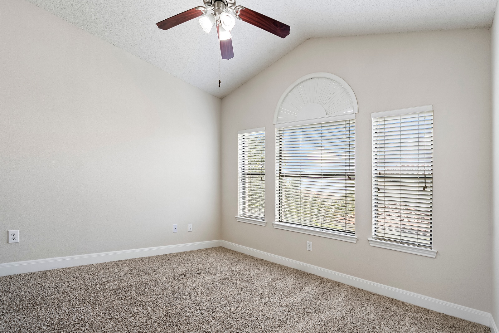 Spacious Bedroom with Arched Window Design