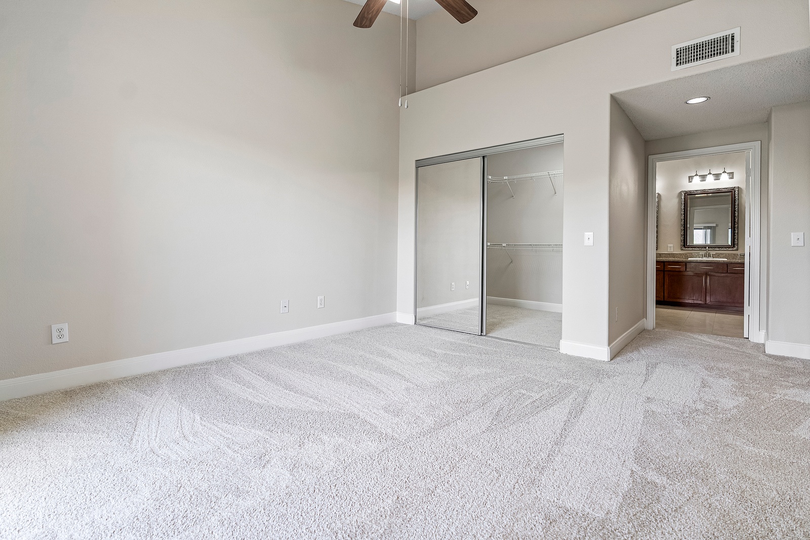 Spacious Bedroom with Mirrored Closet Doors