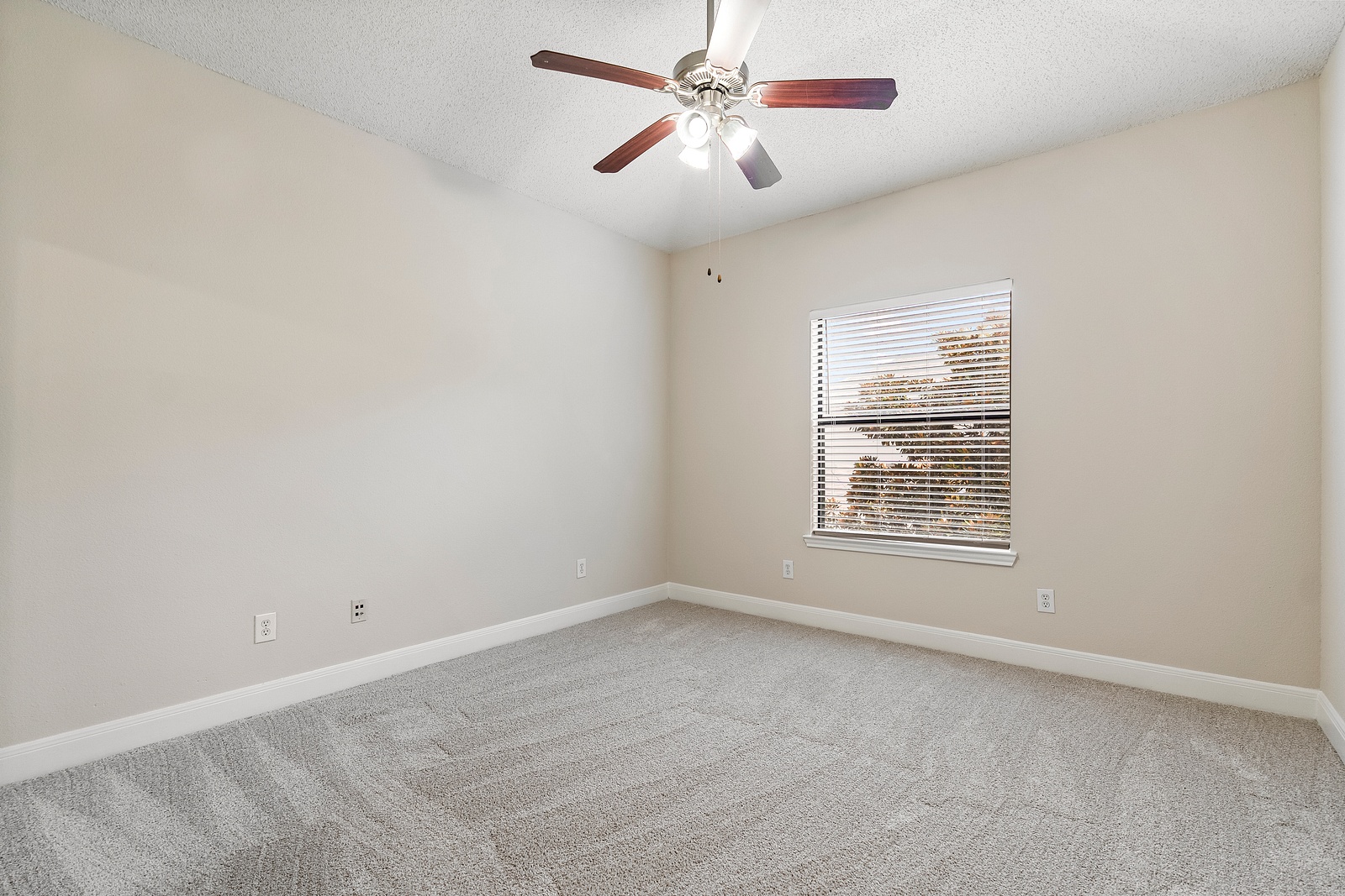 Spacious Bedroom with Plush Carpet Flooring