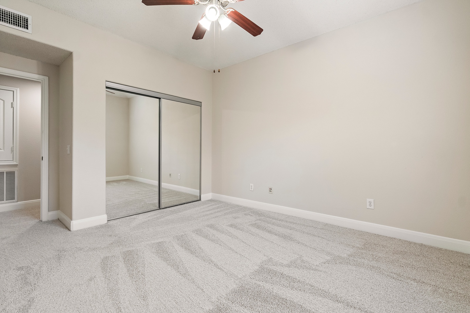 Bedroom with Mirrored Closet Doors